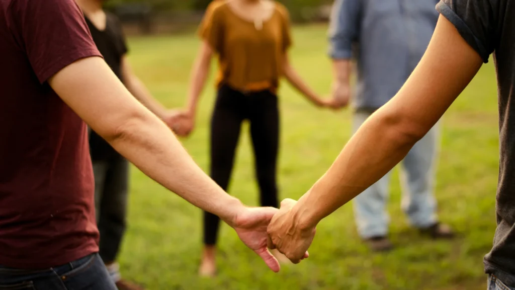 People holding hands in a healing circle